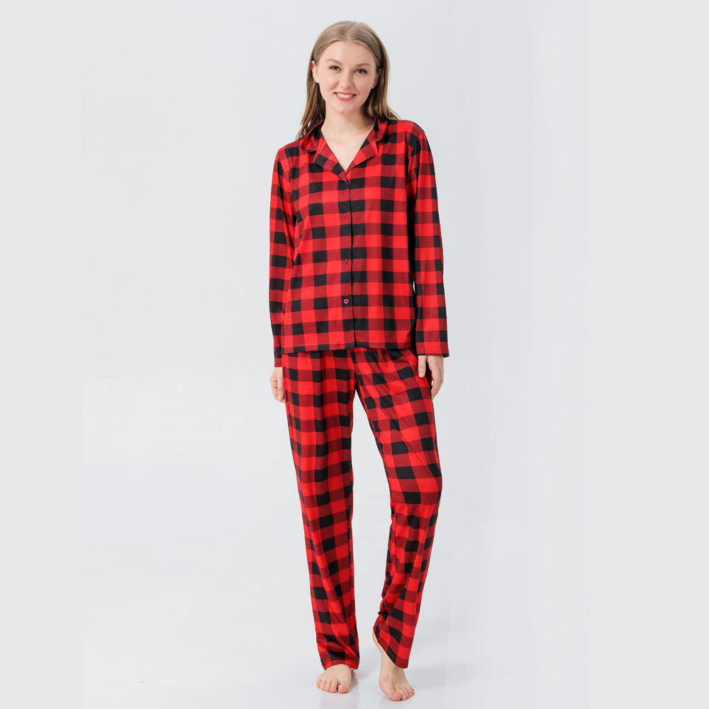 Person wearing red and black plaid pajamas on a light gray background