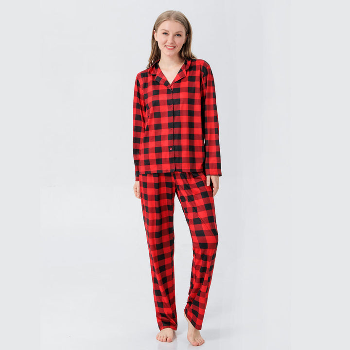 Person wearing red and black plaid pajamas on a light gray background